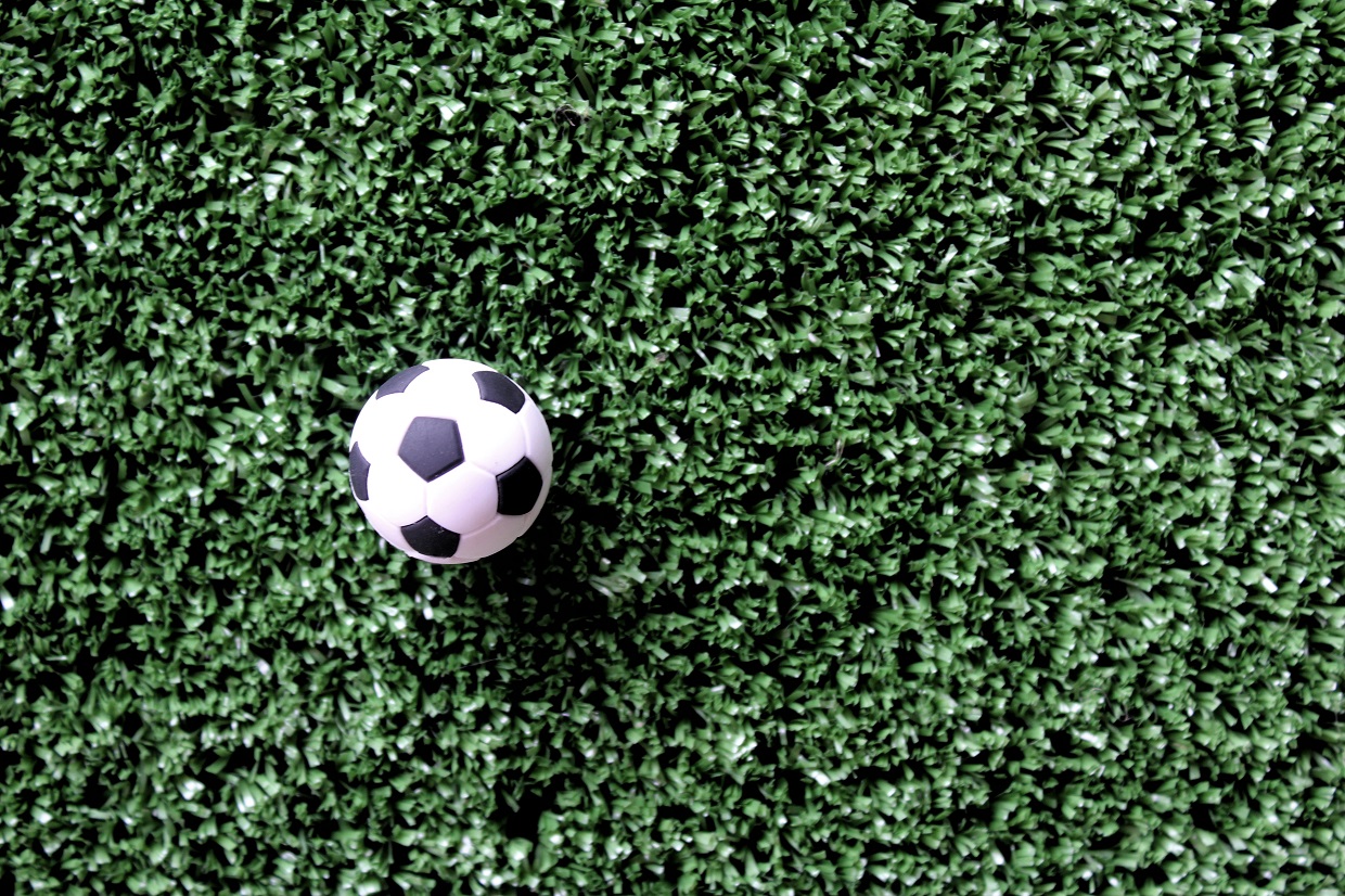 Soccer ball on soccer field with copy space. Sport, football concept.